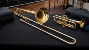 Trombone and trumpet displayed side by side for a brass instrument comparison